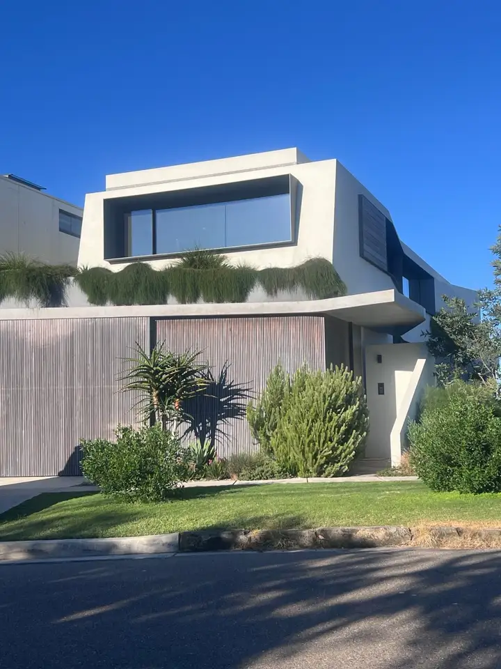 A concrete and timber home with a green roof garden